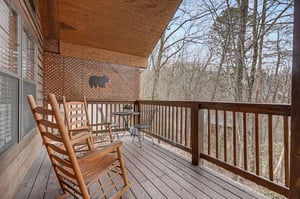 Relax in your private rocking chairs while enjoying peaceful woodland views from this cozy covered deck.
