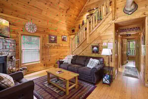 Sofa bed with coffee table and stone fireplace