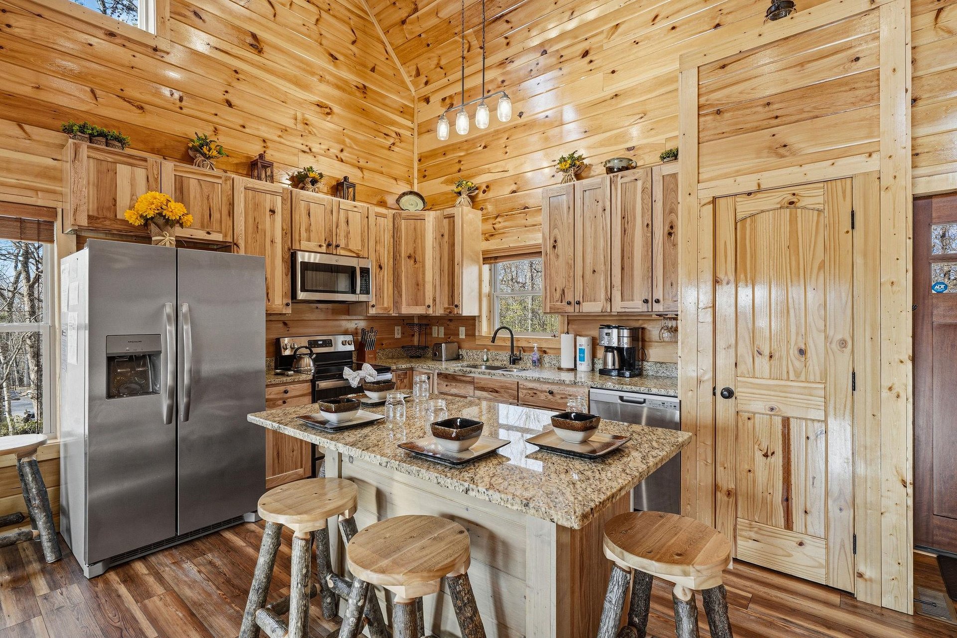 Your rustic kitchen welcomes you with warm knotty pine cabinets, granite countertops, and modern appliances—perfect for creating memorable meals together.
