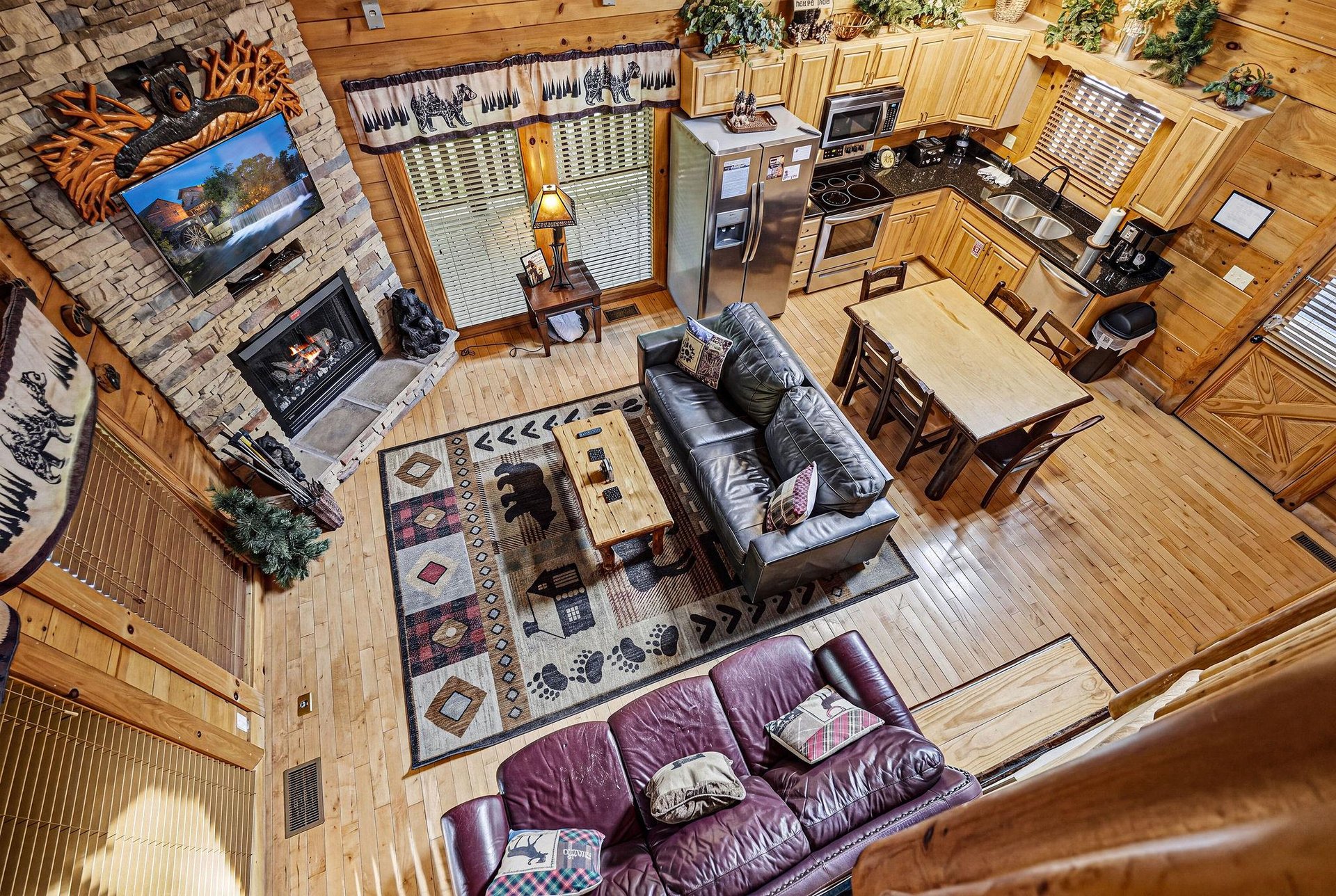 Your spacious openconcept cabin features a cozy stone fireplace, fullyequipped kitchen, and comfortable leather seating—perfect for relaxing after mountain adventures.