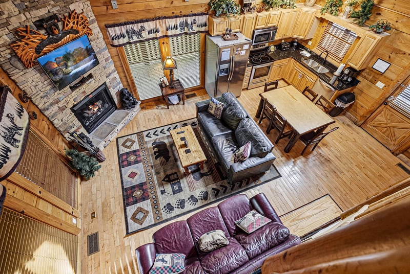 Your spacious openconcept cabin features a cozy stone fireplace, fullyequipped kitchen, and comfortable leather seating—perfect for relaxing after mountain adventures.