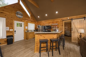 Full kitchen with bar and stools