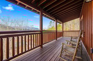 Unwind on your private wooden deck, complete with cozy rocking chairs perfect for morning coffee or evening stargazing.