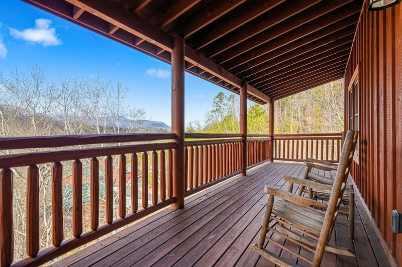 Unwind on your private wooden deck, complete with cozy rocking chairs perfect for morning coffee or evening stargazing.