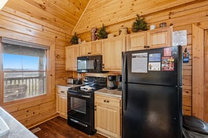 Your fully equipped kitchen features warm wood cabinets, modern appliances, and stunning views through the window while you cook.