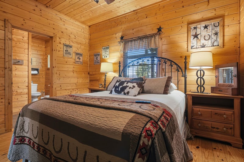 Rustic warmth welcomes you in this cozy bedroom with knotty pine walls and inviting Western accents. Soft lighting and plush bedding create your peaceful retreat after a day of adventure.