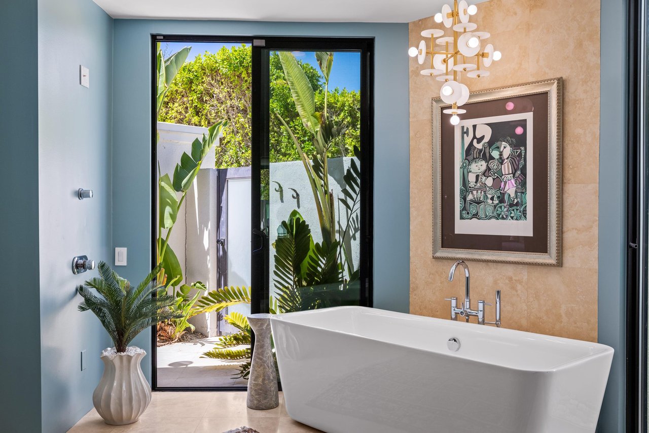 Features a walkin shower, stand alone tub, sliding doors out to an outdoor shower, TV, and large walkin closet.
