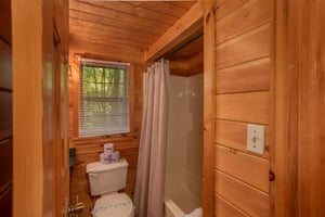 bathroom with tub and shower at angels dream a 1 bedroom cabin rental located in gatlinburg