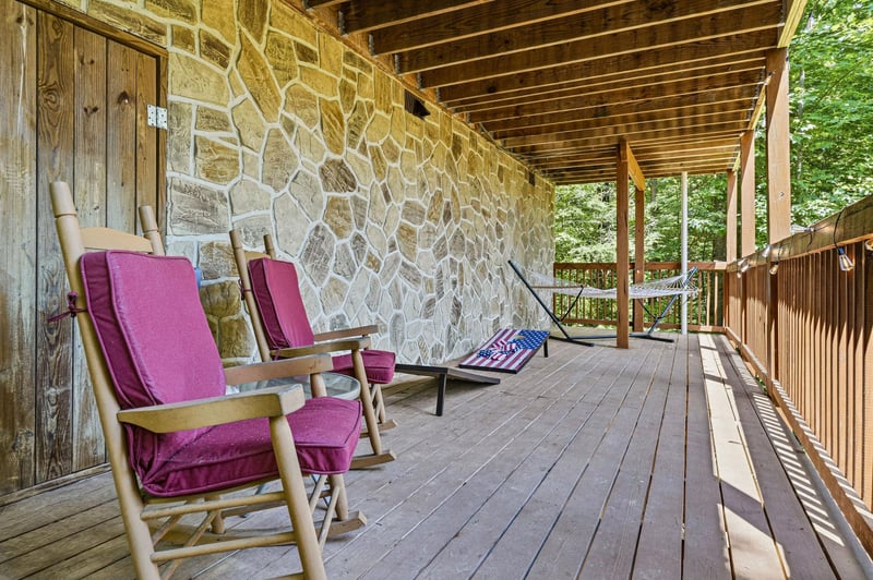 Sink into a cushioned rocking chair on your private covered porch, where peaceful forest views and gentle breezes invite you to slow down and unwind.
