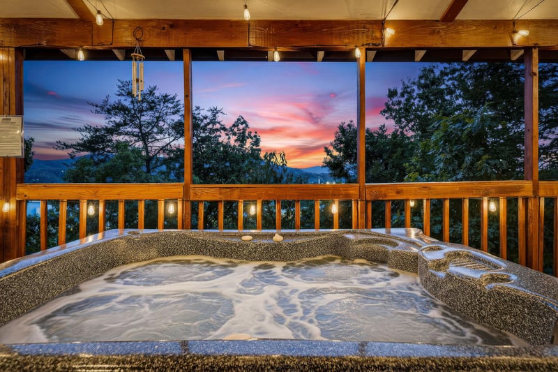 Unwind in your private hot tub as the sky bursts into vibrant pinks and oranges. Surrounded by lush forest, this serene mountain escape invites you to relax and soak in natures beauty.