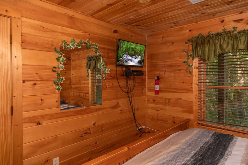 wall mounted television in a bedroom at angels majestic view a 3 bedroom cabin rental located in pigeon forge