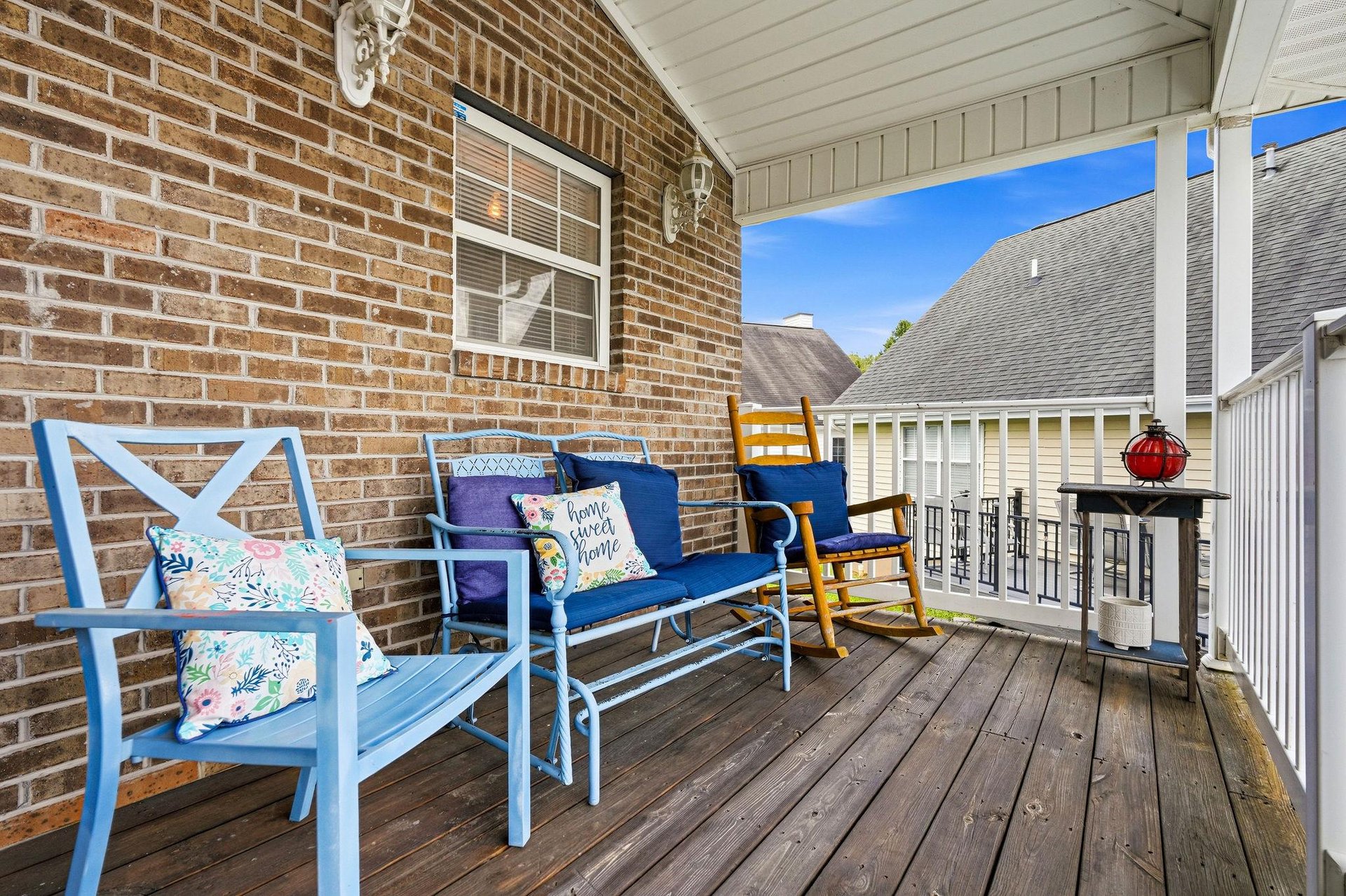 Settle into your private porch with cheerful blue seating and a classic rocking chair—your perfect spot to unwind with morning coffee or an evening glass of wine.