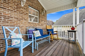 Settle into your private porch with cheerful blue seating and a classic rocking chair—your perfect spot to unwind with morning coffee or an evening glass of wine.
