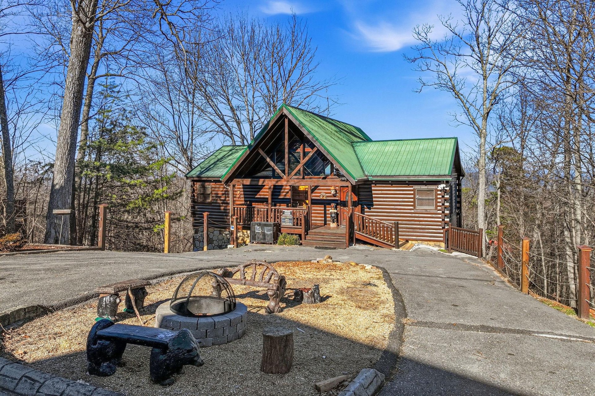 Rustic log cabin retreat with outdoor fire pit area surrounded by peaceful woodland setting.