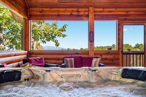 Soak in your private hot tub surrounded by warm wood and sweeping mountain views—pure relaxation at its finest.