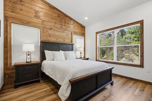 Sink into this cozy bedroom where rustic wood meets modern comfort, your peaceful retreat after mountain adventures.