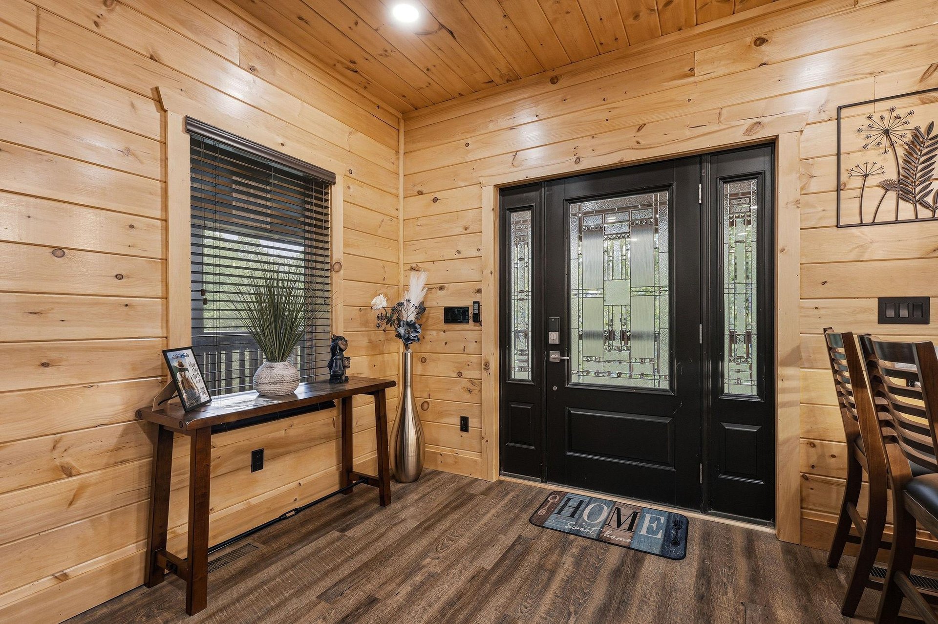 Step into your cozy cabin retreat where warm wood walls and rustic charm create the perfect welcoming atmosphere for your getaway.
