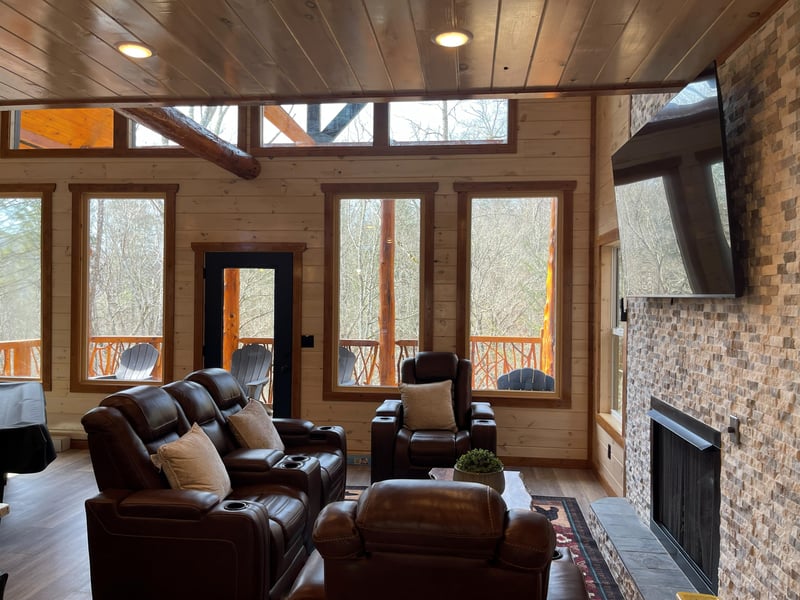 Sink into plush leather recliners by the crackling fireplace, where forest views through floortoceiling windows create your perfect mountain retreat moment.
