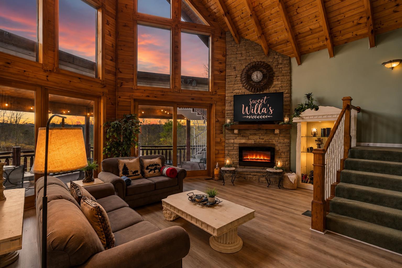 Soaring wood ceilings, huge windows and a cozy electric fireplace make this the perfect place to unwind together