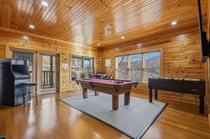 Challenge friends to pool or foosball in this warm cedar game room with arcade fun and scenic windows.