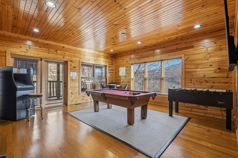 Challenge friends to pool or foosball in this warm cedar game room with arcade fun and scenic windows.