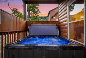 Soak under painted skies in your private hot tub, where forest views and glowing sunsets create the perfect evening escape on your secluded deck.