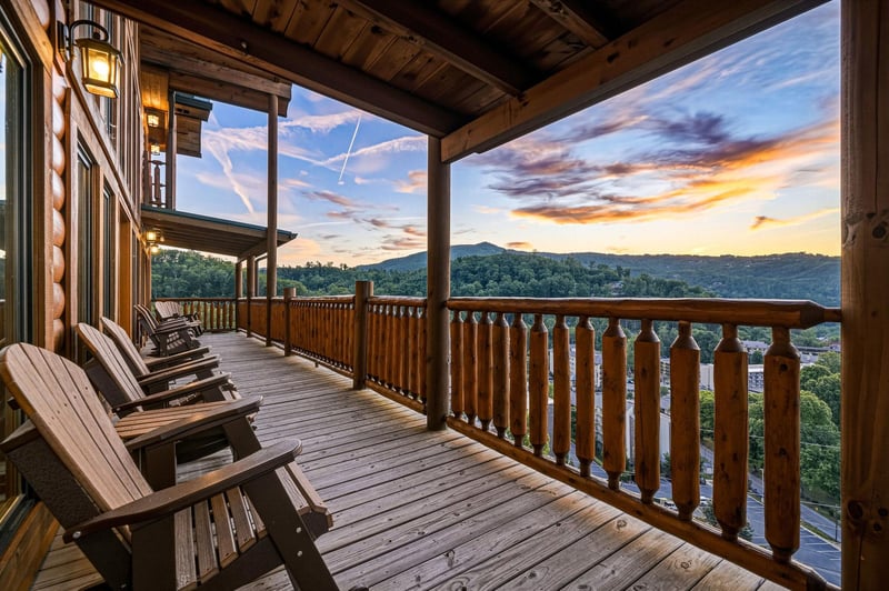 A covered deck overlooking rolling mountains at sunset—complete with rocking chairs for your evening relaxation and mountain views that stretch for miles.