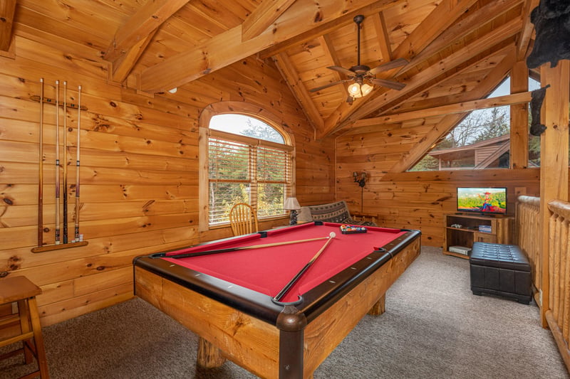 Challenge your group to friendly games of pool in this cozy cabin loft, complete with rustic charm and entertainment center.