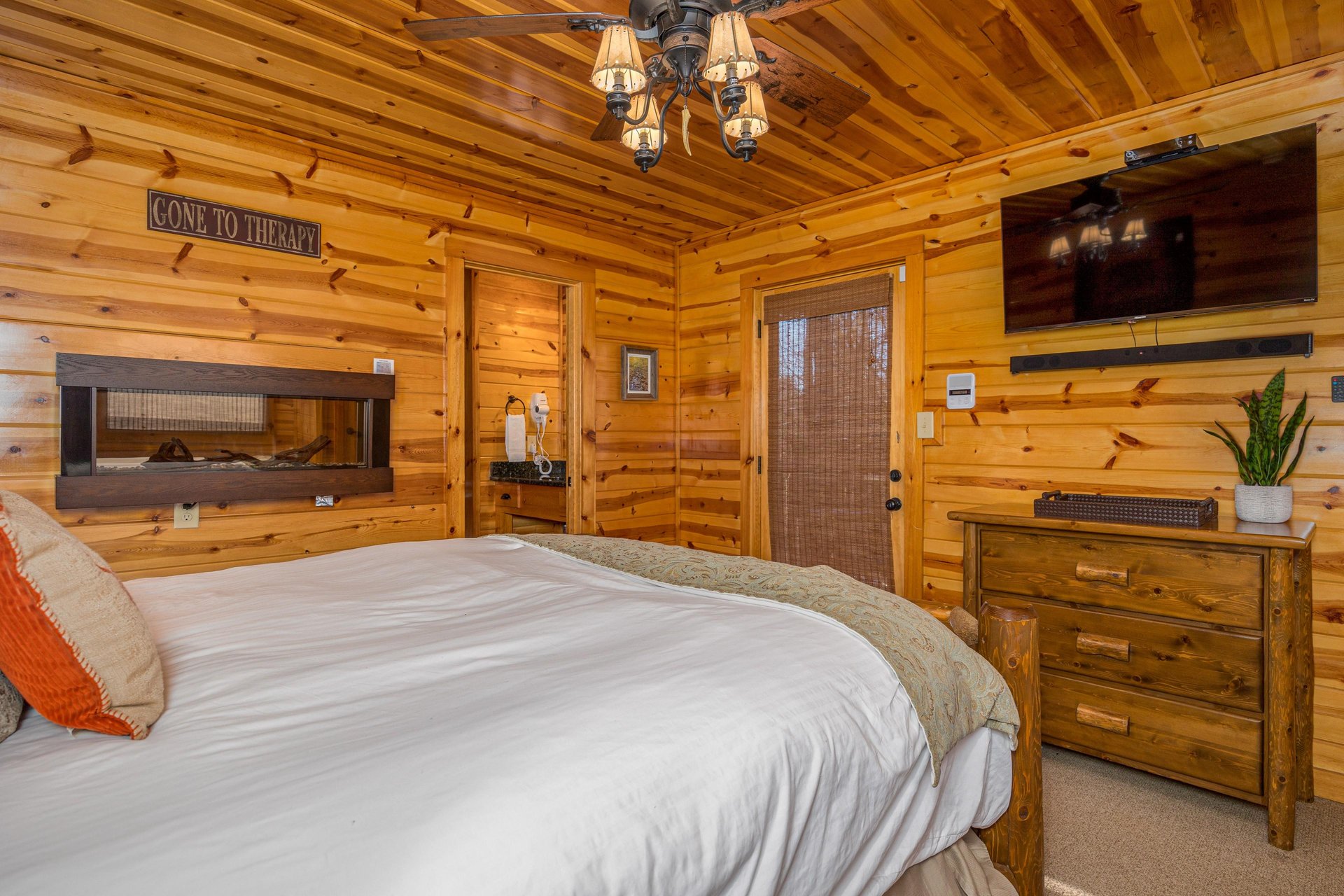 Queen bed with fireplace in wall