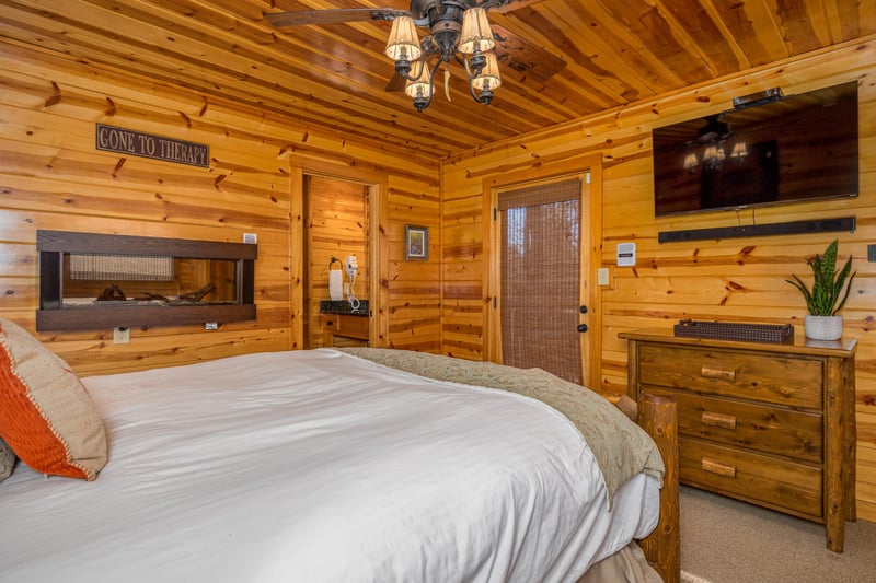 Queen bed with fireplace in wall