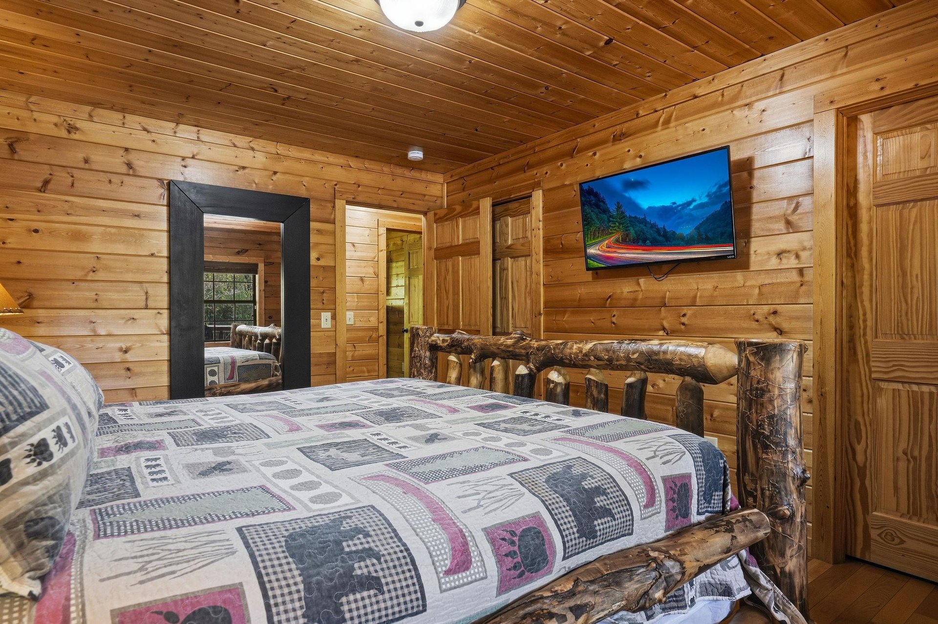 Drift off in your rustic log bedroom, where handcrafted wood beams create a cozy mountain retreat atmosphere.