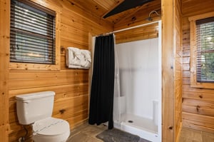 Freshen up in your rusticchic bathroom, where warm pine walls meet modern convenience and soft towels await after your shower.