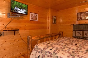 TV in a bedroom at Country Bears Getaway, a 3bedroom cabin rental located in Gatlinburg