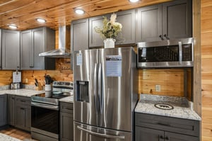 Whip up your favorite meals in this beautifully appointed kitchen with granite countertops, stainless steel appliances, and warm wood accents throughout.