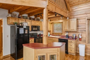 Your fullyequipped kitchen features warm wood cabinets, modern appliances, and a convenient island for preparing meals together.