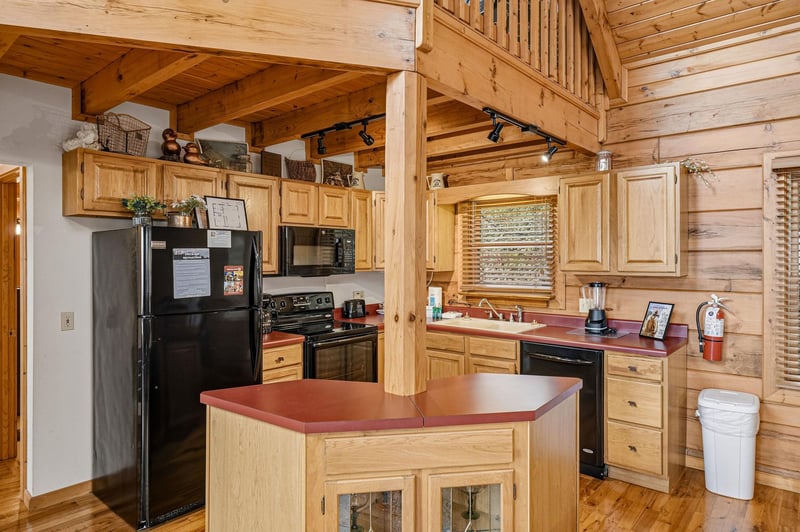 Your fullyequipped kitchen features warm wood cabinets, modern appliances, and a convenient island for preparing meals together.