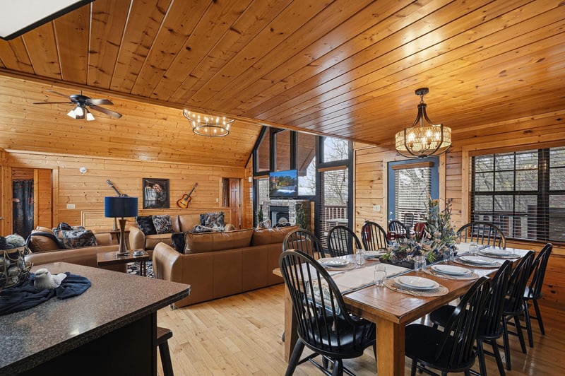 Gather around the rustic dining table while your group relaxes in the cozy living room, all warmed by beautiful wood paneling and natural light.