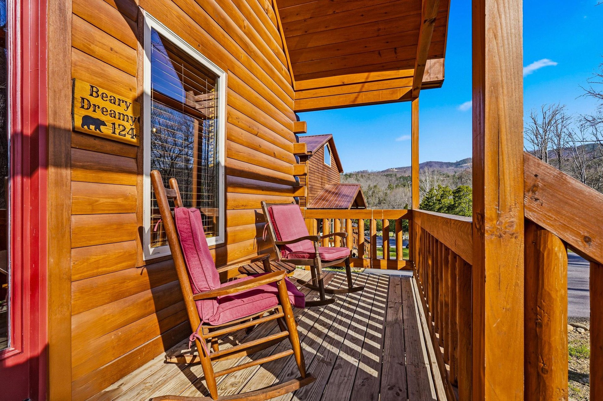 Relax on your private mountain retreat porch with comfortable rocking chairs and stunning views.