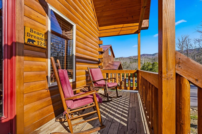Relax on your private mountain retreat porch with comfortable rocking chairs and stunning views.
