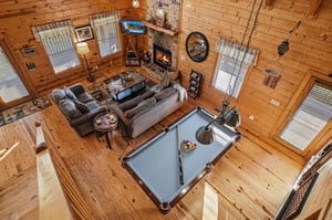 Cozy up by the stone fireplace or challenge friends to billiards in this warm, openconcept cabin retreat with soaring wood ceilings and mountainlodge charm.