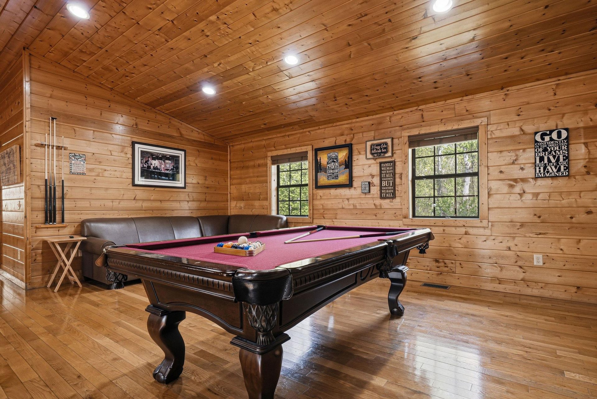 Challenge friends to pool while relaxing on leather seating in your private game room with rustic wood walls and mountain views.