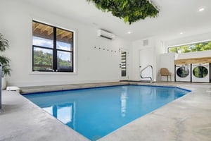 Your own private indoor pool awaits, complete with climate control and natural light streaming through bright windows. Refreshing dips any time of day in this serene, modern space.