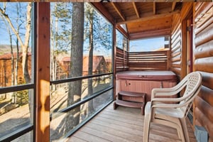 Your private deck features a relaxing hot tub and comfortable seating where you can unwind while soaking in peaceful forest views.
