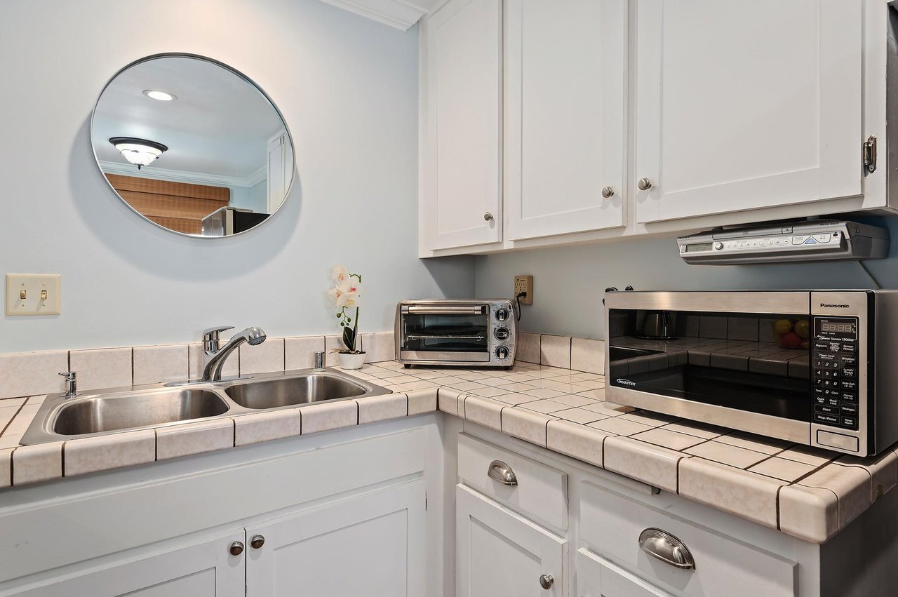Kitchen has toaster oven, microwave and coffee maker