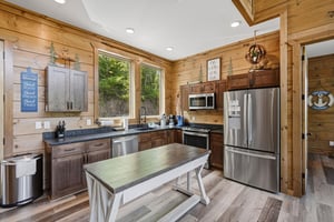 Cook memorable meals in your fully equipped rustic kitchen, featuring modern appliances and warm wood details for the perfect cabin experience.