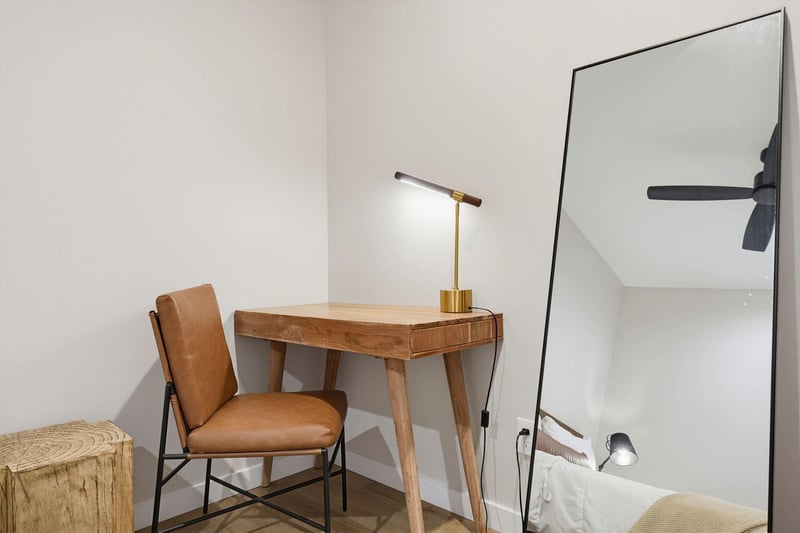 Find your focus at this stylish workspace, where warm wood tones and soft lighting create the perfect spot for catching up on emails or planning your next adventure.