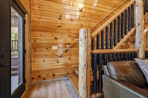 Warm knotty pine walls and rustic railings create your perfect mountain retreat atmosphere with natural wood charm throughout.