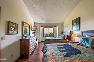 Settle into this cozy bedroom with twin beds, warm wood furnishings, and natureinspired artwork that sets the perfect tone for your adventure.