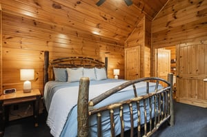 Sink into the rustic charm of this cozy cabin bedroom, where handcrafted wood details and soft linens invite your most restful nights sleep.
