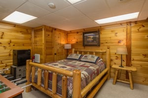 Bedroom with a log bed, night stands, and lamps at Kellys Cabin, a 1 bedroom cabin rental located in Pigeon Forge